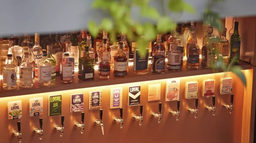 Local Brewing Co. tap wall and spirits selection